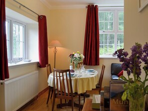 Spacious living/dining room with electric woodburner and wooden floor | Laundry Cottage, Ceannacroc
