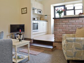 Cosy lounge with open aspect to kitchen | Ramscliff Cottage - Wellington Farm, Priddy, near Wells