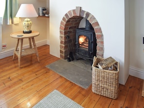 Living area with wooden floor and wood burner | Rowan Cottage, Aislaby, near Whitby