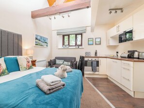 Fully equipped kitchen, seating area and bedroom with dramatic high ceiling | The Stable Nest - The Stables Apartments, Bowness on Windermere