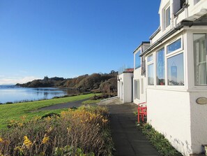 External view showing part of the Bay and garden | South Bay Cottage, Saasaig, Teangue, Isle of Skye