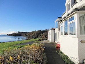 External view showing part of the Bay and garden | South Bay Cottage, Saasaig, Teangue, Isle of Skye