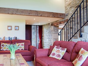 Living room with exposed stone walls and open staircase to first floor | Stable Cottage - Town End Farm Cottages, Airton, near Skipton