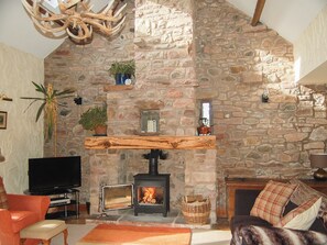 Imposing living room with open fireplace and wood burner | Garden Cottage - Hole House Farm Cottages, Pooley Bridge, nr. Ullswater
