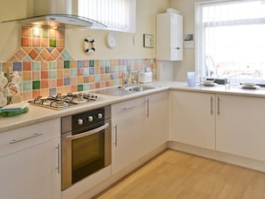 Well-equipped fitted kitchen with breakfast bar | Seashells, Newbiggin-by-the-Sea, near Morpeth