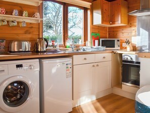 Well equipped kitchen area | Ty Glan Mor (The Beach House) - Water’s Edge Cottages, Llanfaes, Beaumaris, Anglesey