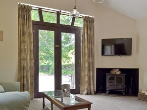 Thoughtfully renovated living room with woodburner | Waterfall Cottage - Lumsdale Cottages, Lumsdale, Tansley Wood, near Matlock