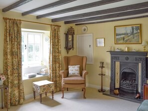 Exposed wooden beams and feature fireplace in living room | , 