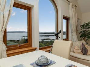 Open plan living space with magnificent views over Broadford Bay | Seabird Cottage, Broadford, Isle of Skye