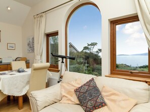 Open plan living space with magnificent views over Broadford Bay | Seabird Cottage, Broadford, Isle of Skye