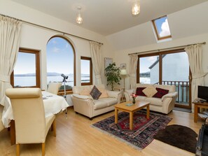 Open plan living space with magnificent views over Broadford Bay | Seabird Cottage, Broadford, Isle of Skye