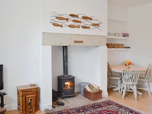 Cosy living area with wood burner | Dipper Cottage, Seahouses