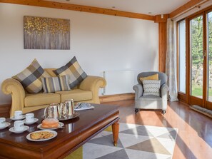 Comfortable living area with doors to the garden | The Roundel, Balmullo, near St Andrews