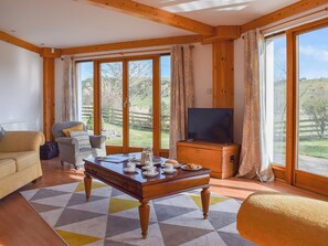 Light and airy living/dining room with three sets of French doors | The Roundel, Balmullo, near St Andrews