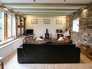 Living room with exposed stone wall & wood burner | Meadow Barn, Pennerley, Minsterley