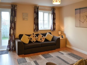 Living room with French doors leading to the garden | Puffin Place, Beadnell, near Seahouses