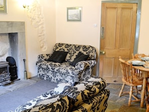 Intimate dining area within living room | Langcliffe Lock Cottage, Langcliffe, near Settle