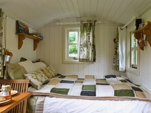 Bedroom area with double sofa bed | Ty Bach Shepherds Hut, Franksbridge, near Builth Wells