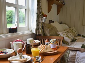 Dining area and double sofa bed | Ty Bach Shepherds Hut, Franksbridge, near Builth Wells