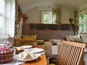 Dining area and double sofa bed | Ty Bach Shepherds Hut, Franksbridge, near Builth Wells