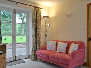 Stylish living room with French doors to patio | Garden Farm Cottage, Ilam, near Ashbourne