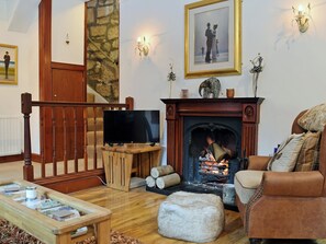 Warm and welcoming living/dining room with open fire | The Gate House, Markinch, near Glenrothes
