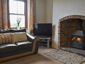 Welcoming living room with wood burner | Bettws y Gwynt, Llanbedrgoch, near Benllech