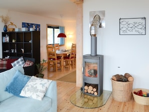 Warm and welcoming wood burner heating the whole house in the living room | Fionn Croft Lodge, Melvaig, near Gairloch