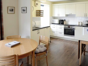 Spacious dining area and well-equipped fitted kitchen | Birch Cottage - Glenrossal Cottages, Rosehall, near Lairg