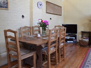 Beamed ceiling and feature brick fireplace make the dining area cosy and warm | Brook Barn - Brook and Meadow Barns, Shobley, Ringwood