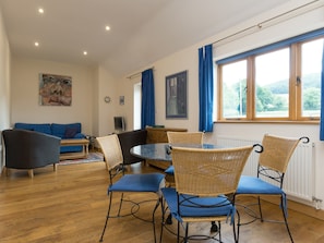 Stylish dining area separates lounge from kitchen | Parkers Lodge - Netherley Hall Cottages, Mathon, near Malvern