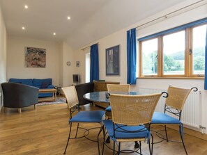 Stylish dining area separates lounge from kitchen | Parkers Lodge - Netherley Hall Cottages, Mathon, near Malvern