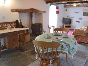 Flag-floored dining area with woodburner | Meadwell - Trebarwith Farm Cottages, Trebarwith, Delabole