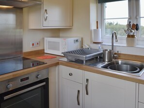 The kitchen is modest yet up to date and has everything you need | Garden Cottage, Edlingham, near Alnwick