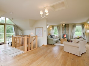 Large living room with wood-burning stove and oak floors | Carness West, North Ballachulish, Glencoe