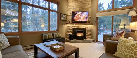 Our living room features a stunning fireplace and beautiful outdoor views