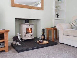 Living room with wood burner and French doors leading to patio | Toad Hall, Aberfeldy