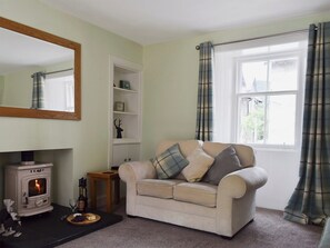 Living room with wood burner and French doors leading to patio | Toad Hall, Aberfeldy