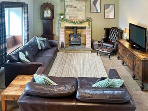 Cosy lounge with wood burning stove & wood beamed ceiling  | Old Kielder Castle Cottage, Kielder, near Bellingham