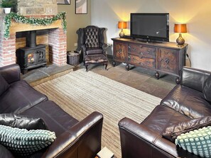 Cosy lounge with wood burning stove & wood beamed ceiling  | Old Kielder Castle Cottage, Kielder, near Bellingham