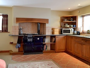 Modern fitted farmhouse-style kitchen area with Rayburn | Grange Farm Cottage, Spaunton, near Lastingham