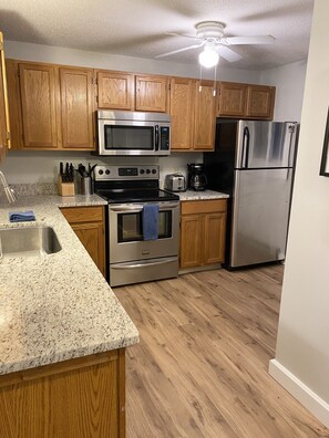Fully stocked kitchen with granite countertops 