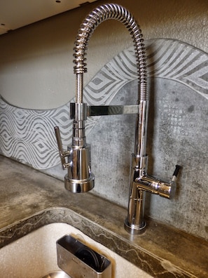 Kitchen faucet with concrete backsplash