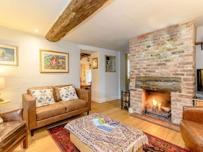 Welcoming living room with open fire | The Smithy, Brassington, near Matlock
