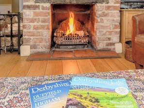 Welcoming living room with open fire | The Smithy, Brassington, near Matlock