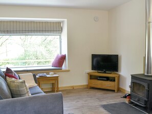 Cosy living area with wood burner and window seat  | Riverside Cottage, Boreland, near Lockerbie