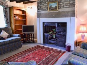 Living room with ornamental period range | Timberwick Green - Akeld Manor, Akeld, Wooler