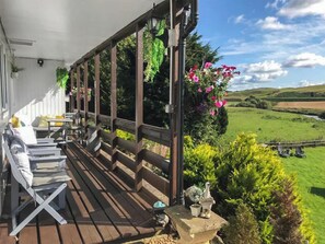 Sit out and relax on the covered porch in all seasons  | Harperfield Chalet, Lanark