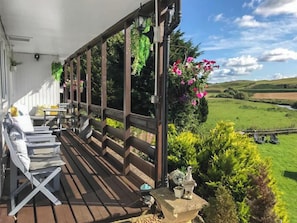 Sit out and relax on the covered porch in all seasons | Harperfield Chalet, Lanark