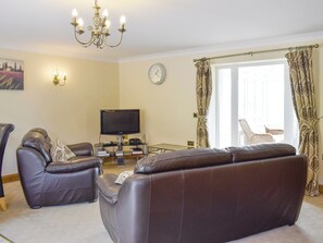 Welcoming living area with conservatory access | No 1 Pengraig Draw - Pengraig Cottages, Near Llanfarian